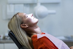 Woman with blonde hair relaxed in the dental chair