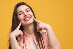 woman smiling at her cosmetic dentist in Syracuse