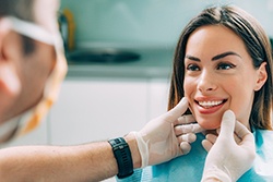 patient smiling after paying cost of cosmetic dentistry in Syracuse