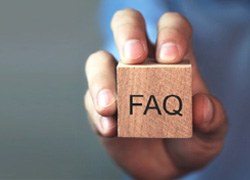 Holding a block with the letters “FAQ”