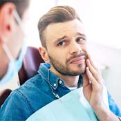Concerned woman calling her Syracuse emergency dentist