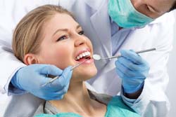 Woman getting dental checkup and cleaning in Syracuse