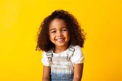 Young girl smiling after children’s dentistry in Syracuse