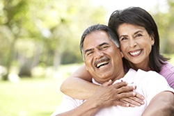 Couple smiling together while sitting outside