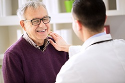 Patient and dentist discussing the price of dental implants in Syracuse