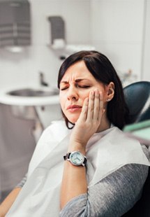 Woman with toothache at dentist's office