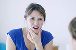 Woman suffering from jaw pain