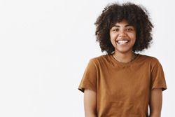 smiling older teen or young adult with a white background 