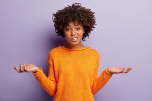 confused woman in a orange shirt